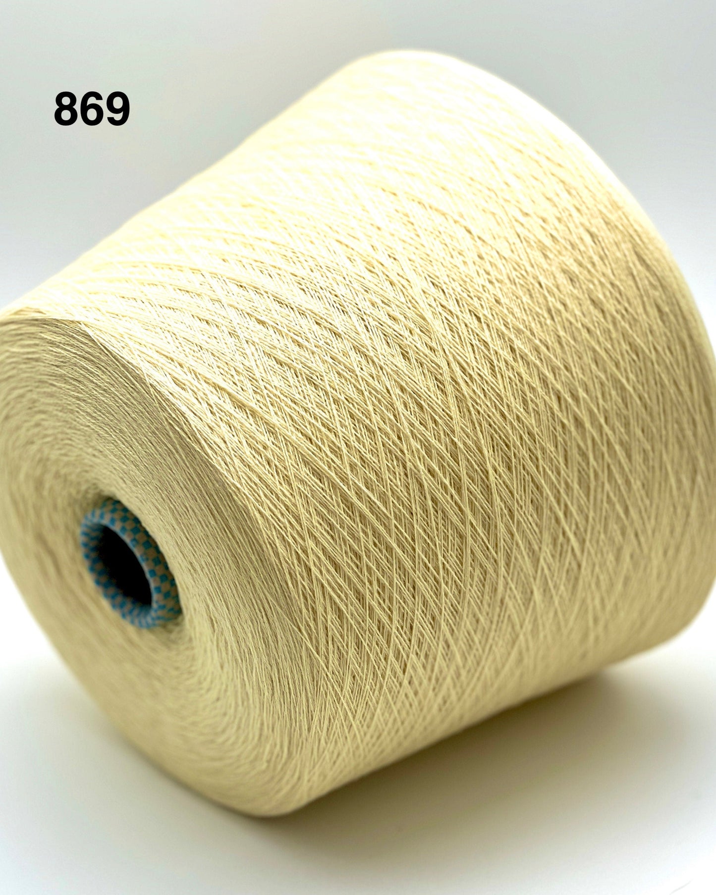 Spool of beige yarn on a white background