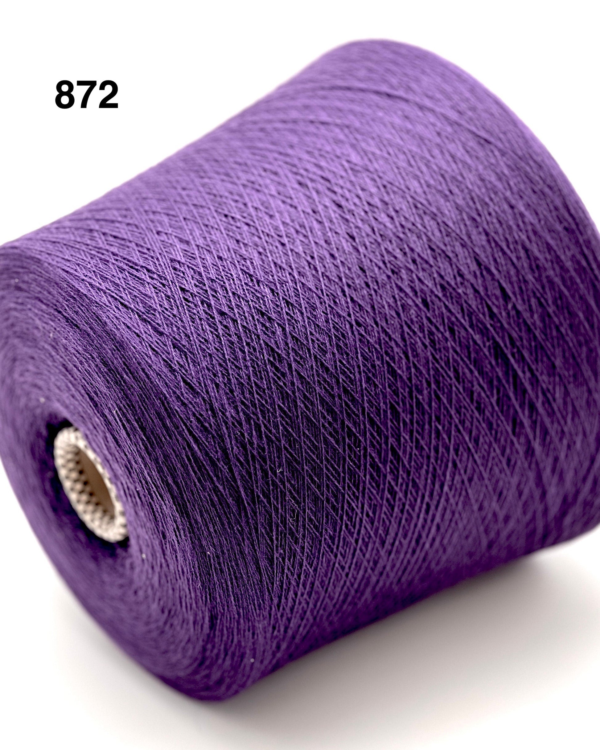 Purple spool of thread on a white background