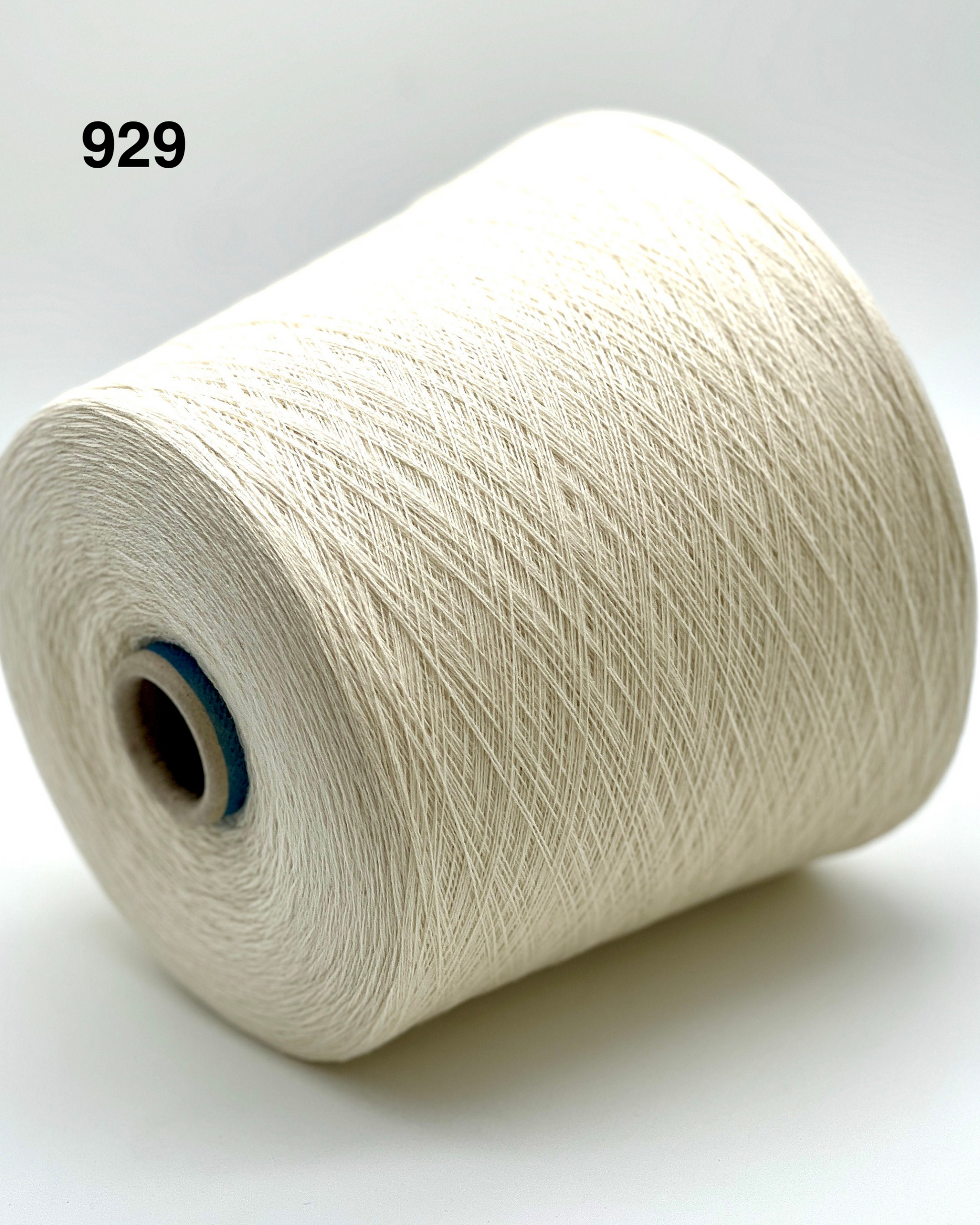 Spool of white yarn on a light gray background