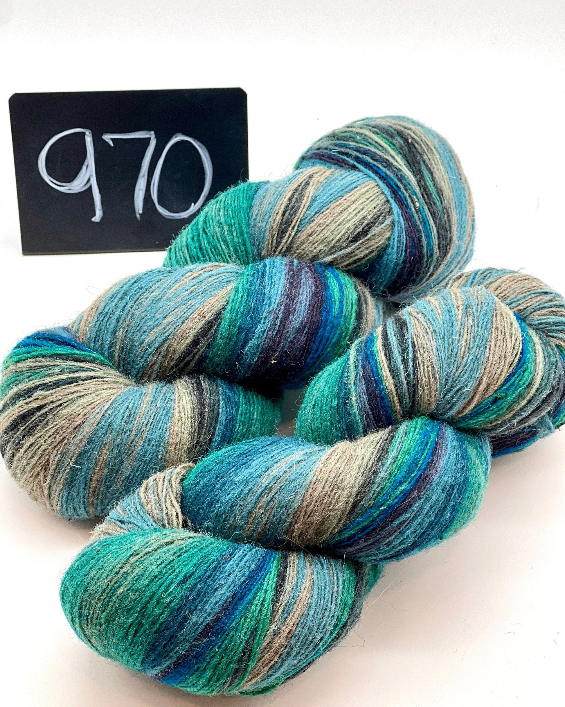 DUNDAGA 6/1 fingering weight single-ply yarn – 70% Latvian wool and 30% Merino blend, high lanolin content for a soft rustic feel, shown in hand-dyed gradients. Ideal for durable socks and heritage knitting with authentic European wool. Available at iDOKNiT.com.