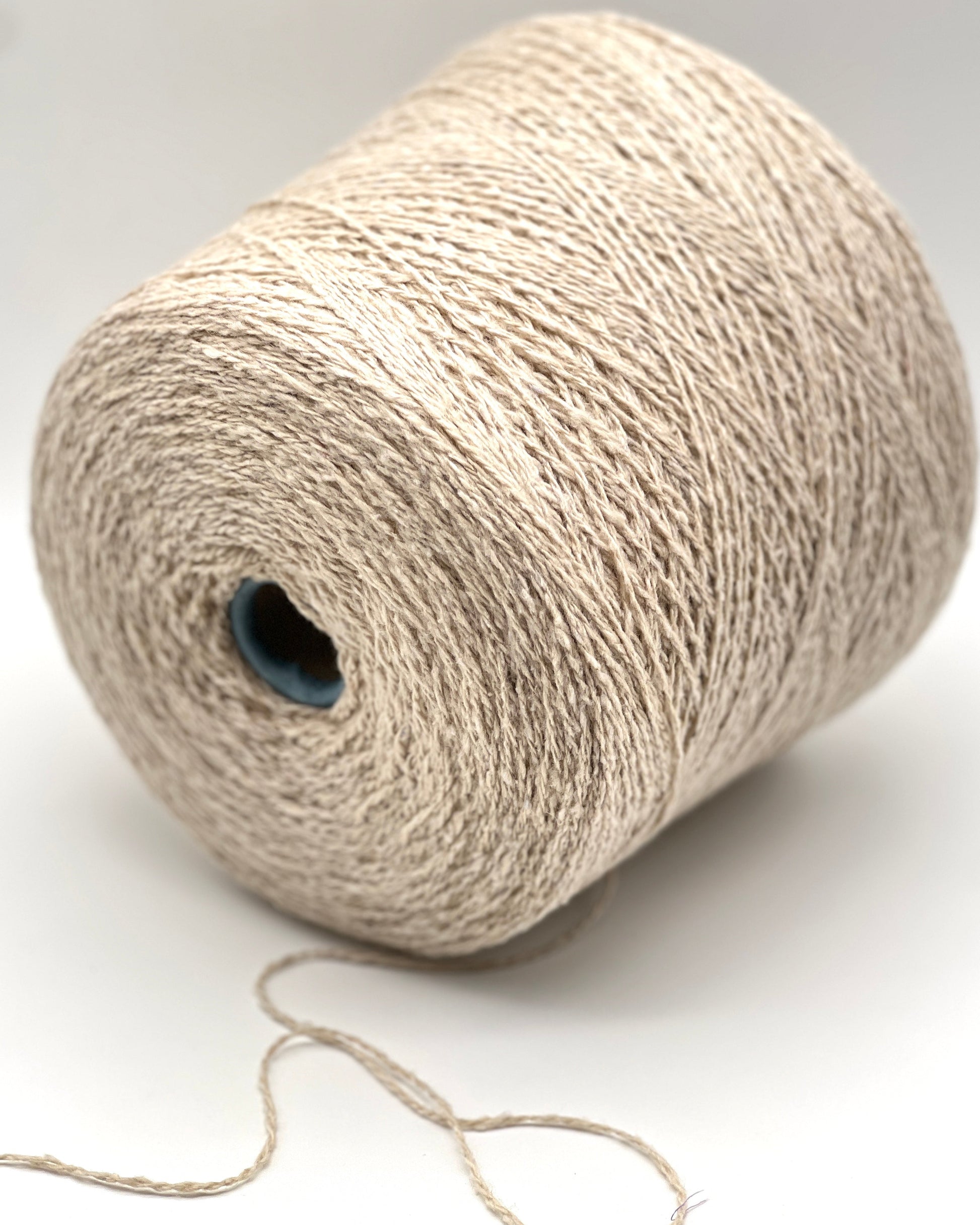 Gruppo Tessile Industriale WEB TWEED Italian cashmere yarn shown on professional cones. This 100% carded cashmere sport weight yarn features a subtle, modern tweed texture and soft loft. Premium luxury designer yarn available at iDOKNiT.com.