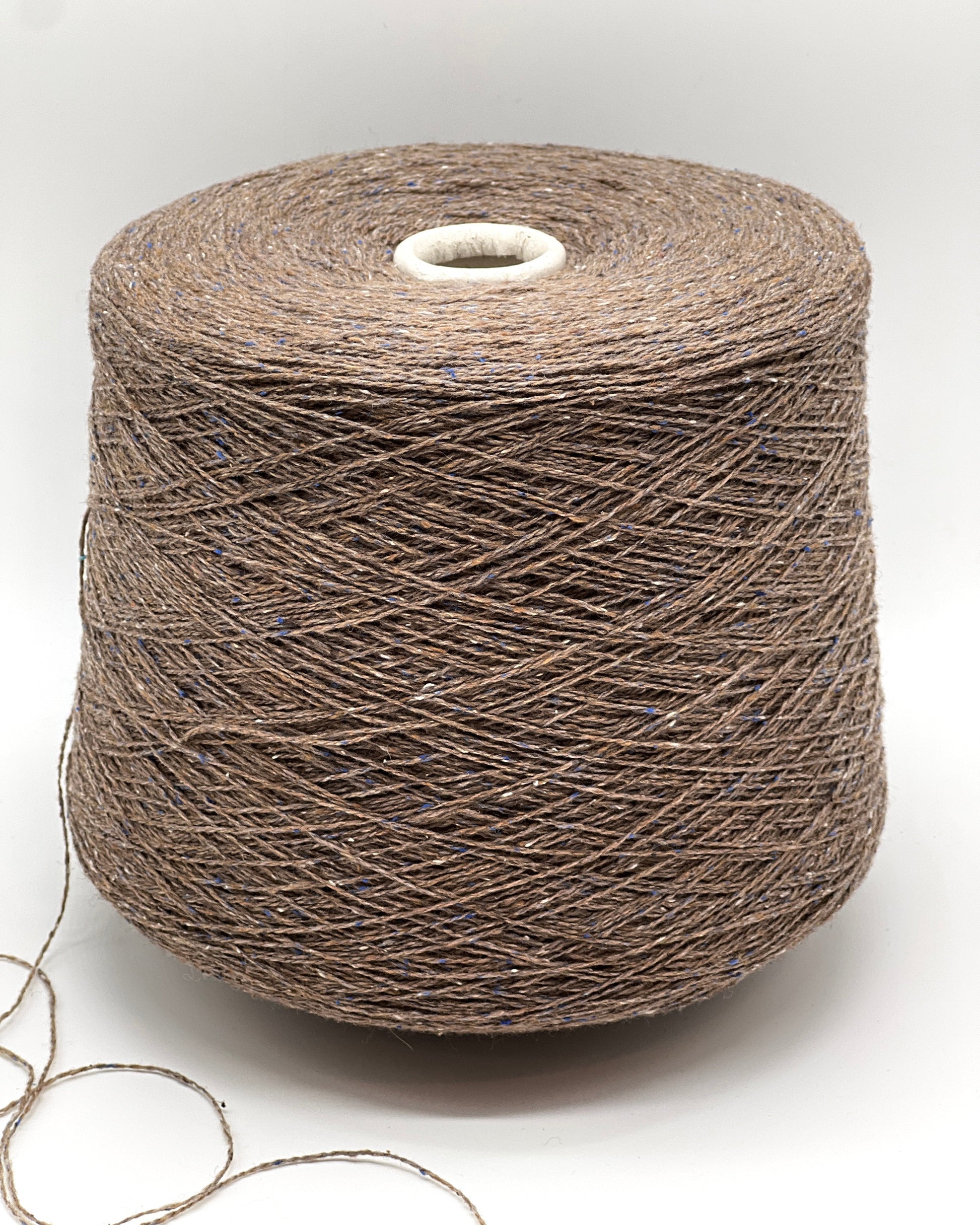 Luxury iDOKNiT lace weight tweed yarn, PIGALLE by RiGo Italy. Sophisticated blend of 40% virgin wool and 20% silk, 750m/100g. Authentic Italian-made tweed featuring a cocoa base with blue and cream flecks, curated by iDOKNiT for elegant, multi-textured garments with a soft silk finish.