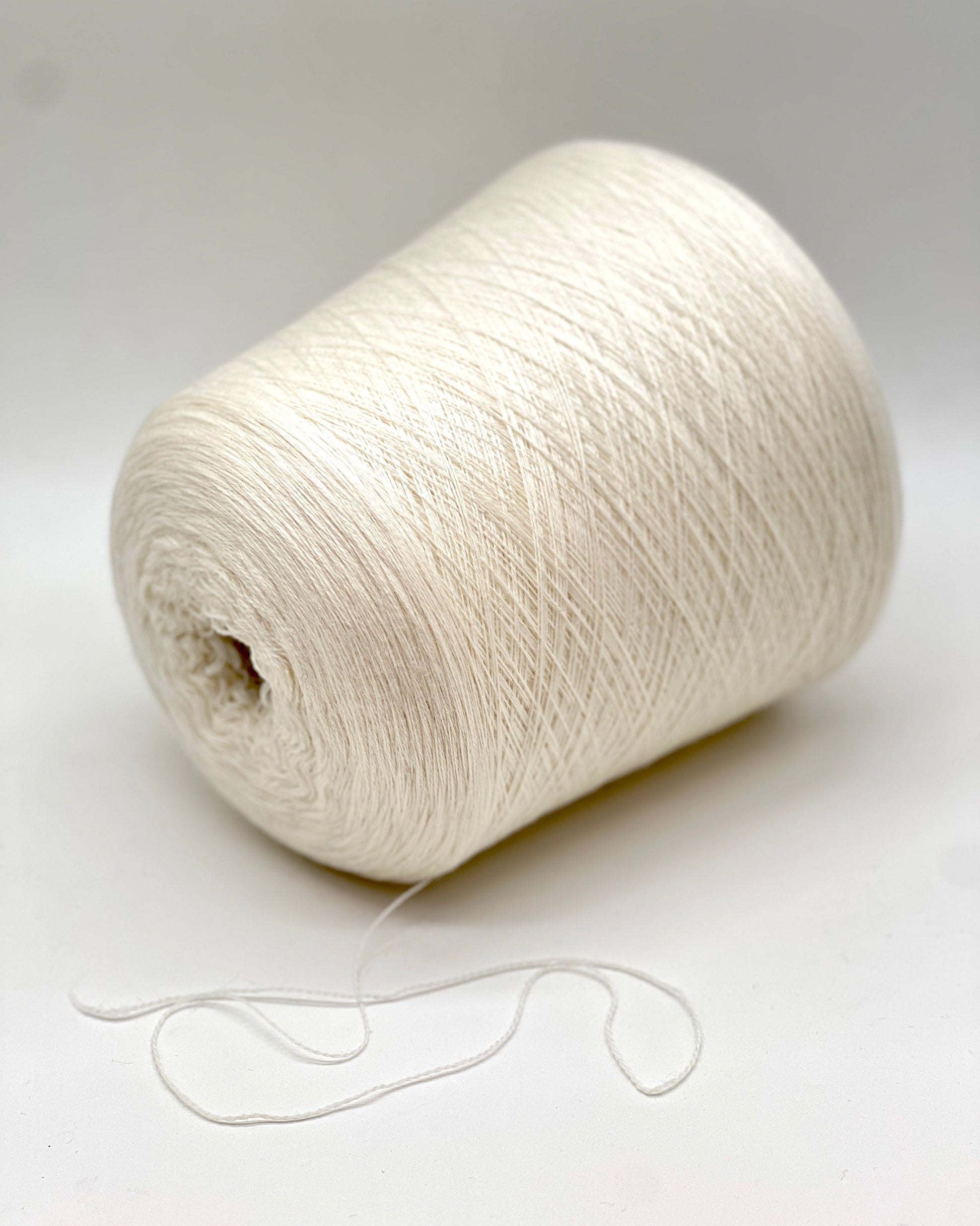 Elite iDOKNiT extra fine lace weight yarn, MASCOTTE by RiGo Italy. Luxury blend of 20% cashmere and 80% merino wool, Nm 2/30, providing 1500m per 100g. Authentic Italian-made yarn in 2153 Ecru Natural, curated by iDOKNiT for delicate lace knitting and high-end, ultra-soft garments.