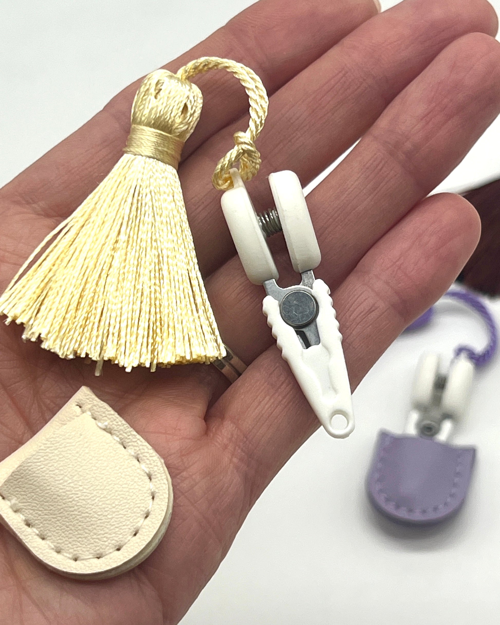 Professional iDOKNiT mini precision thread scissors for crafters. These 42mm spring-style snips feature a decorative tassel and protective cover, designed for sharp, precise trimming of yarn and embroidery floss. Compact and travel-ready accessory curated by iDOKNiT for knitting, crochet, and sewing project bags.