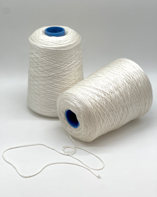 Luxury iDOKNiT fingering weight yarn, SETA SHAPPE by RiGo Italy. 100% Seta Shappe Silk featuring a sophisticated chainette structure for superior breathability and drape, 420m/100g. Authentic Italian-made silk on cones, color 2153 White, curated by iDOKNiT for elite hand and machine knitting projects.