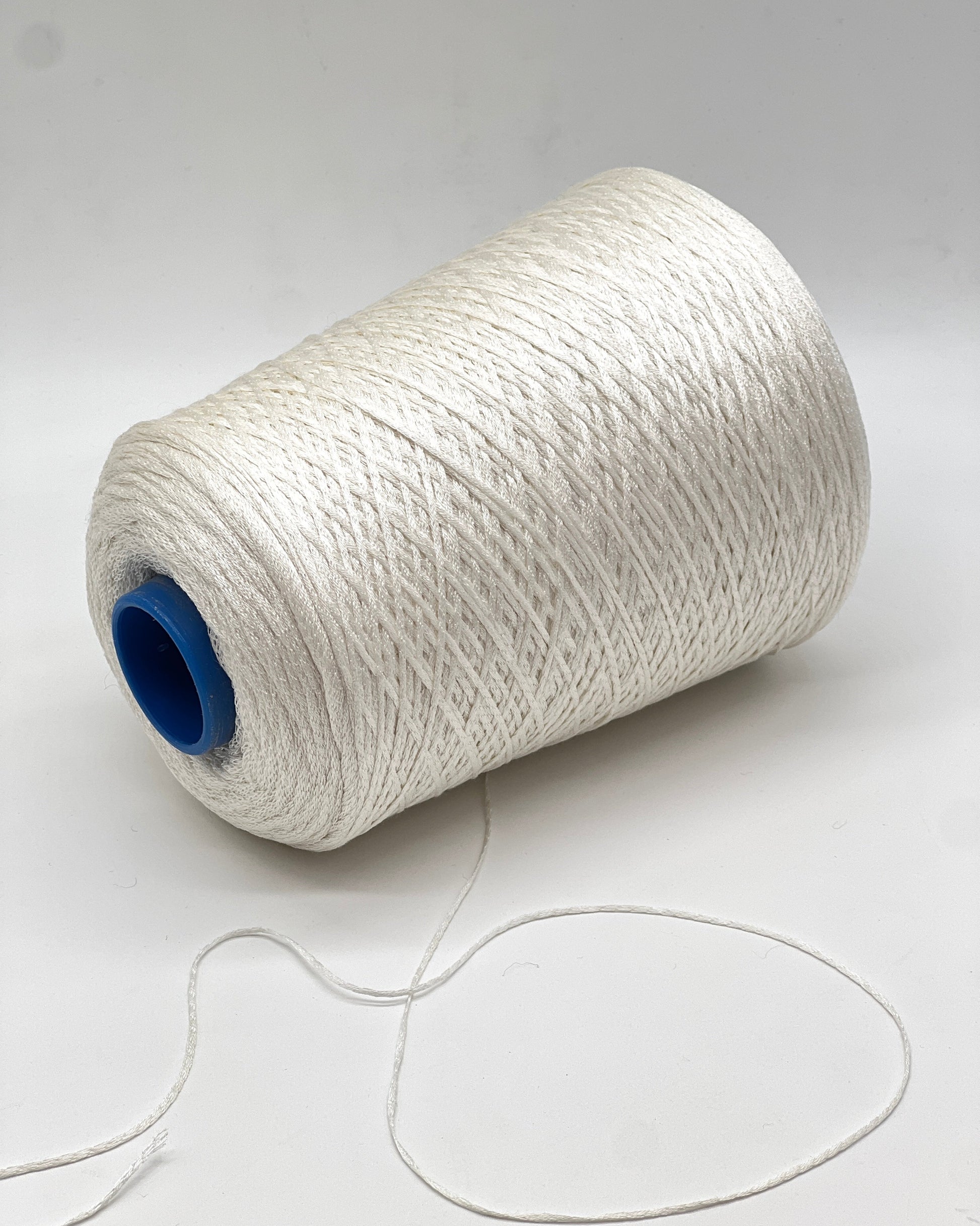 Luxury iDOKNiT fingering weight yarn, SETA SHAPPE by RiGo Italy. 100% Seta Shappe Silk featuring a sophisticated chainette structure for superior breathability and drape, 420m/100g. Authentic Italian-made silk on cones, color 2153 White, curated by iDOKNiT for elite hand and machine knitting projects.