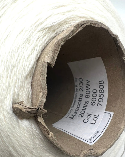 Luxury iDOKNiT fingering weight yarn, SETA SHAPPE by RiGo Italy. 100% Seta Shappe Silk featuring a sophisticated chainette structure for superior breathability and drape, 420m/100g. Authentic Italian-made silk on cones, color 2153 White, curated by iDOKNiT for elite hand and machine knitting projects.