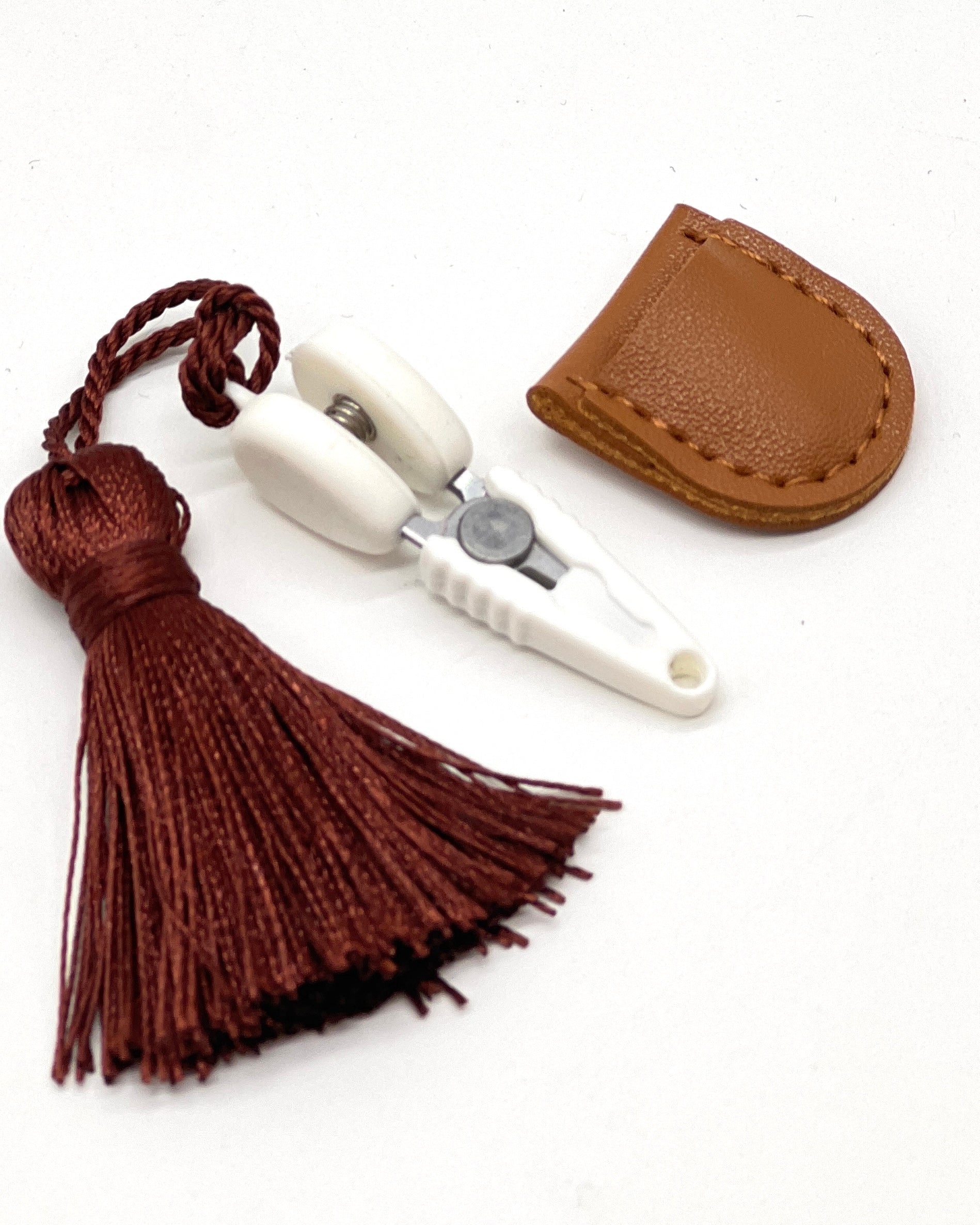 Professional iDOKNiT mini precision thread scissors for crafters. These 42mm spring-style snips feature a decorative tassel and protective cover, designed for sharp, precise trimming of yarn and embroidery floss. Compact and travel-ready accessory curated by iDOKNiT for knitting, crochet, and sewing project bags.