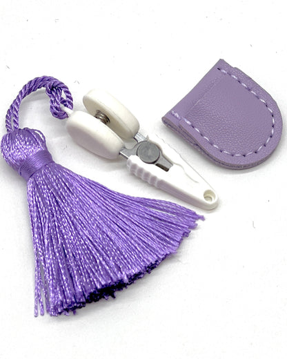 Professional iDOKNiT mini precision thread scissors for crafters. These 42mm spring-style snips feature a decorative tassel and protective cover, designed for sharp, precise trimming of yarn and embroidery floss. Compact and travel-ready accessory curated by iDOKNiT for knitting, crochet, and sewing project bags.