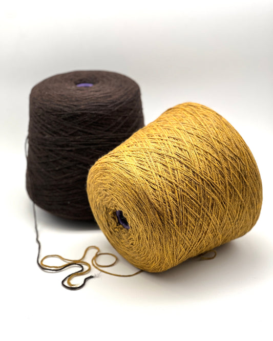 Two skeins of yarn, one brown and one beige, on a white background.