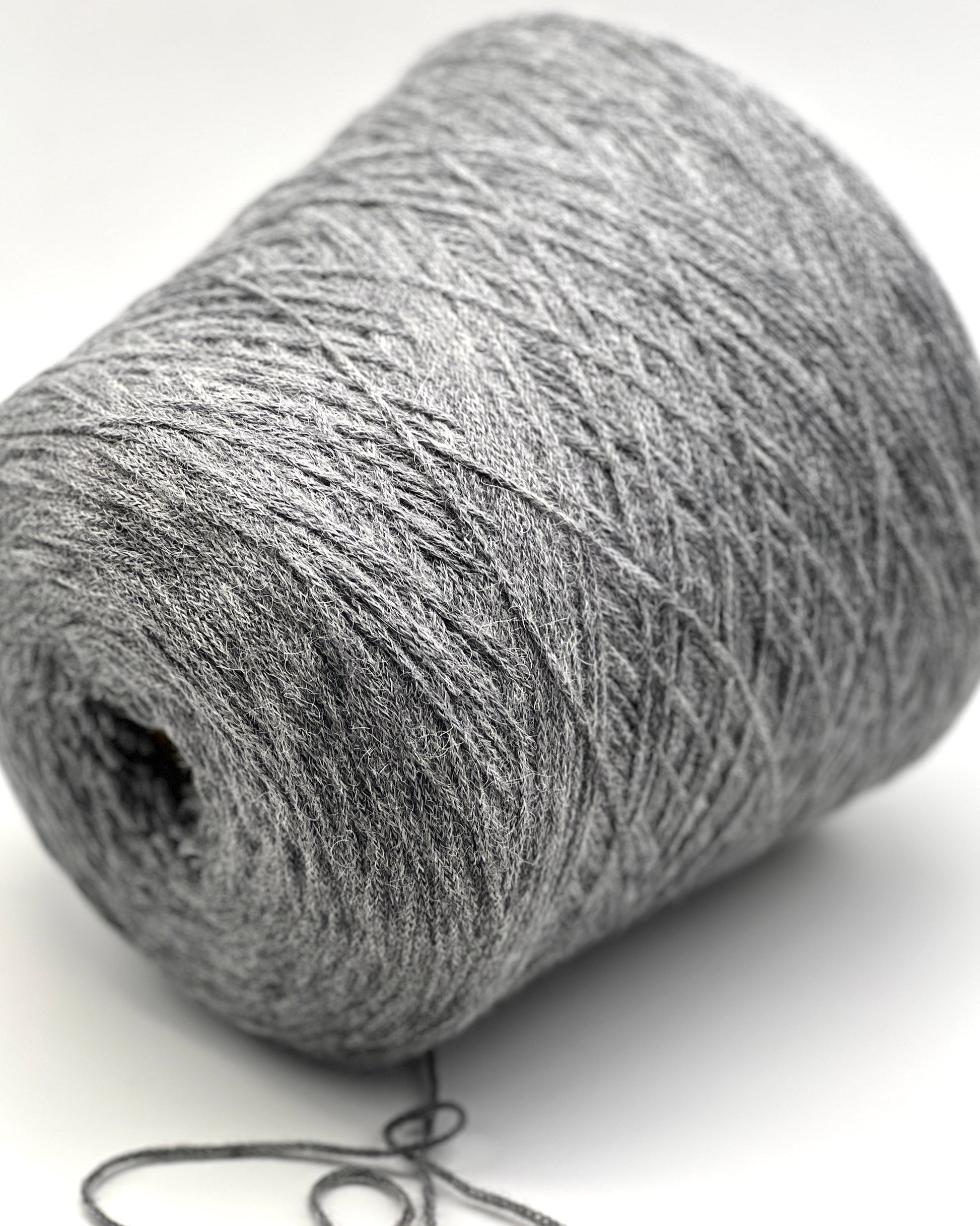 Close-up of a gray skein of yarn on a white background