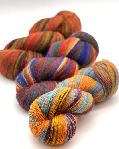 DUNDAGA 6/1 fingering weight single-ply yarn – 70% Latvian wool and 30% Merino blend, high lanolin content for a soft rustic feel, shown in hand-dyed gradients. Ideal for durable socks and heritage knitting with authentic European wool. Available at iDOKNiT.com.