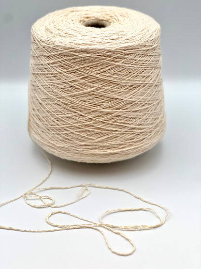 Cone of COTTON FLAME Italian flammé cotton yarn in natural cream color, premium sport weight cotton yarn for sweaters, cardigans, tops, and summer knitwear.