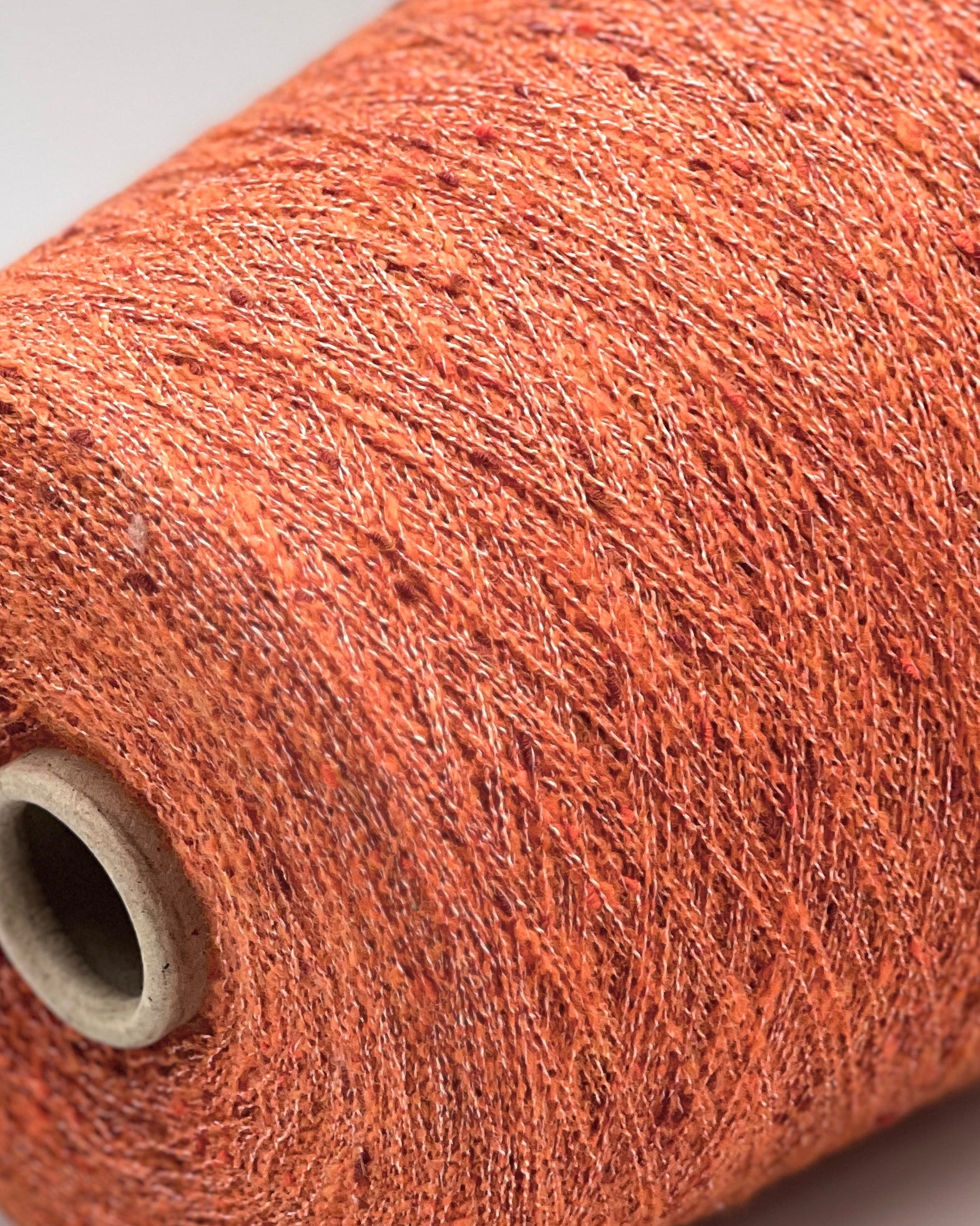 Exclusive iDOKNiT extra fine lace weight yarn, TORRONCINO by Pecci Filati Italy. A luxury fashion tweed yarn blend of 10% cashmere, 48% cotton, 20% merino wool, and 22% polyamide providing 700m per 100g. Authentic Italian-made premium fiber curated by iDOKNiT for lightweight standalone knitting, fine gauge machine knitting, and carrying with companion bases.
