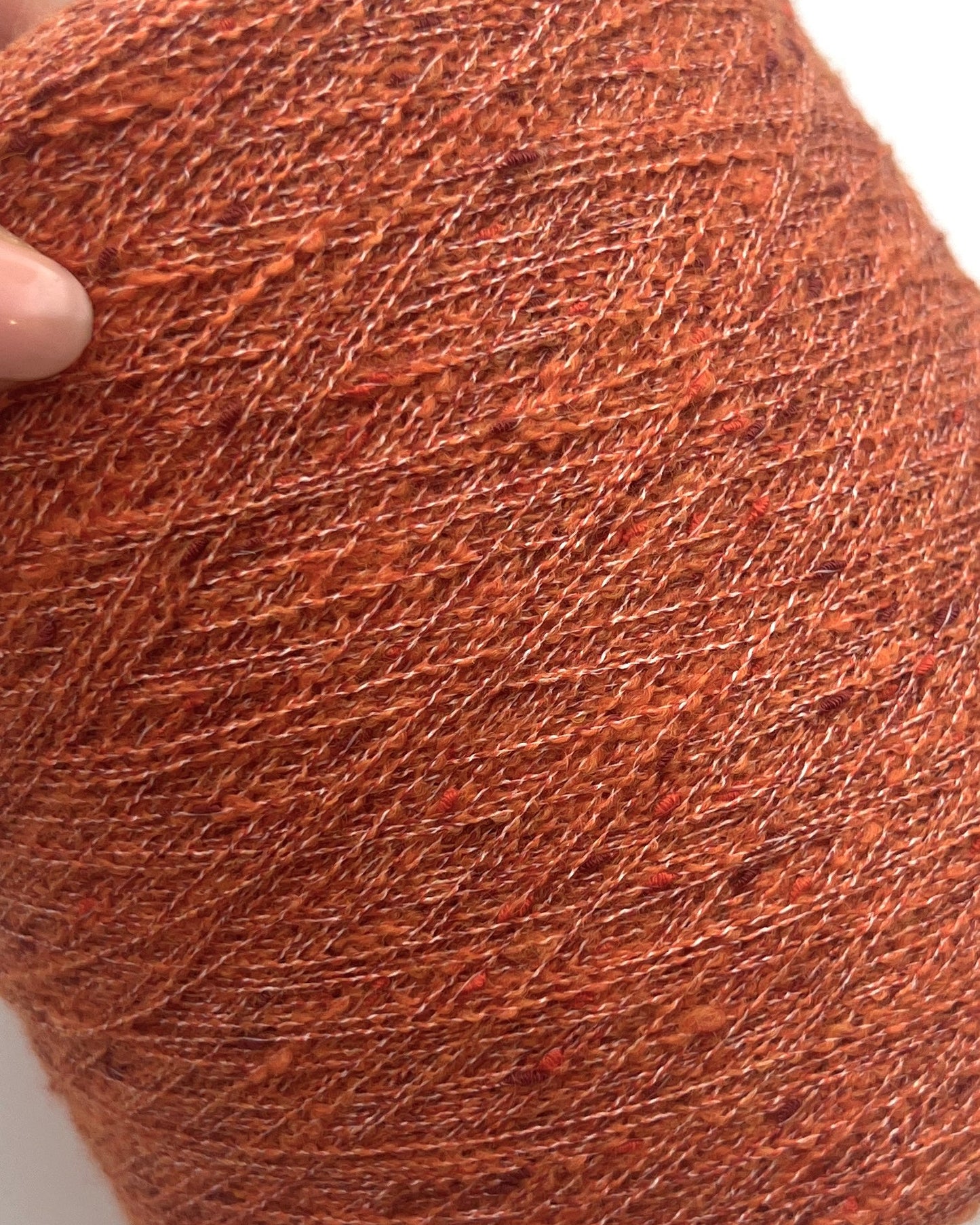 Exclusive iDOKNiT extra fine lace weight yarn, TORRONCINO by Pecci Filati Italy. A luxury fashion tweed yarn blend of 10% cashmere, 48% cotton, 20% merino wool, and 22% polyamide providing 700m per 100g. Authentic Italian-made premium fiber curated by iDOKNiT for lightweight standalone knitting, fine gauge machine knitting, and carrying with companion bases.
