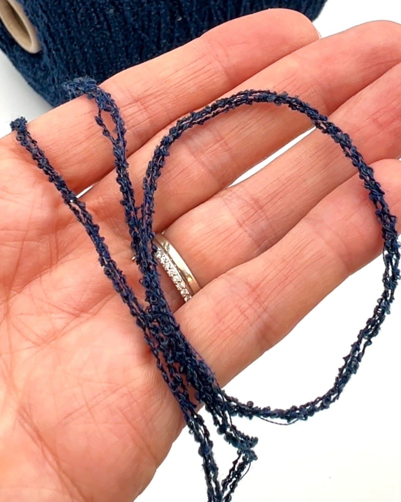 G&G Filati FRIZZ luxury 50% merino wool and 50% silk blend Italian sport weight fantasy boucle yarn in Midnight Blue with integrated 2mm transparent paillettes sequins for runway-ready fashion knitwear at iDOKNiT.