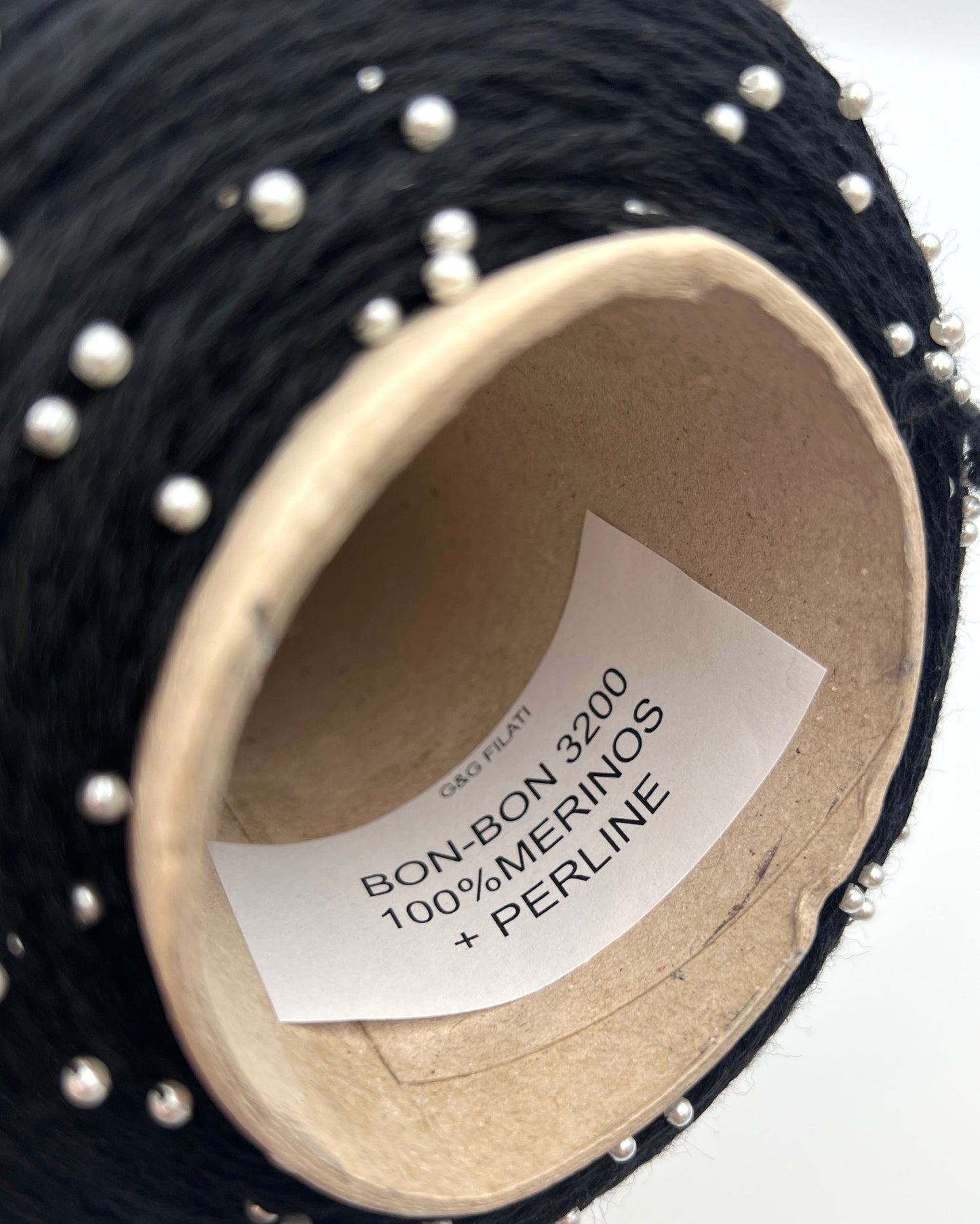 G&G Filati BON-BON luxury 100% merino wool single ply sport weight yarn featuring integrated, generously spaced perline pearl beads wound on an industrial cone for high-end boutique knitwear.