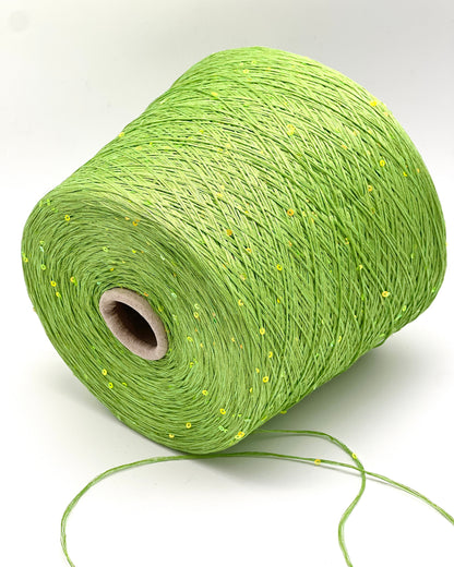 Green spool of yarn on a white background