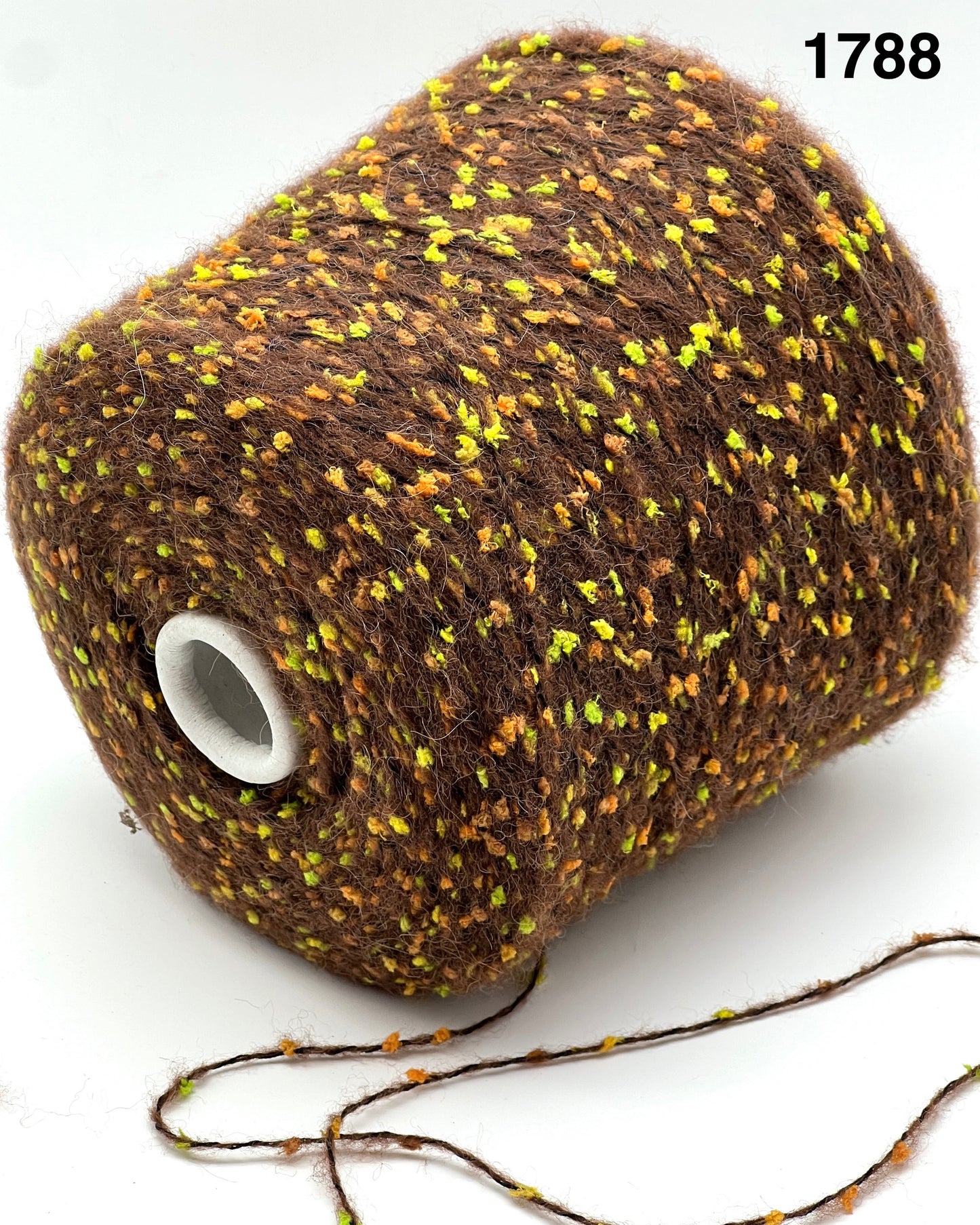 COLOR 1788 CHOCOLATE MULTI - Spool of brown yarn with specks of yellow on a white background