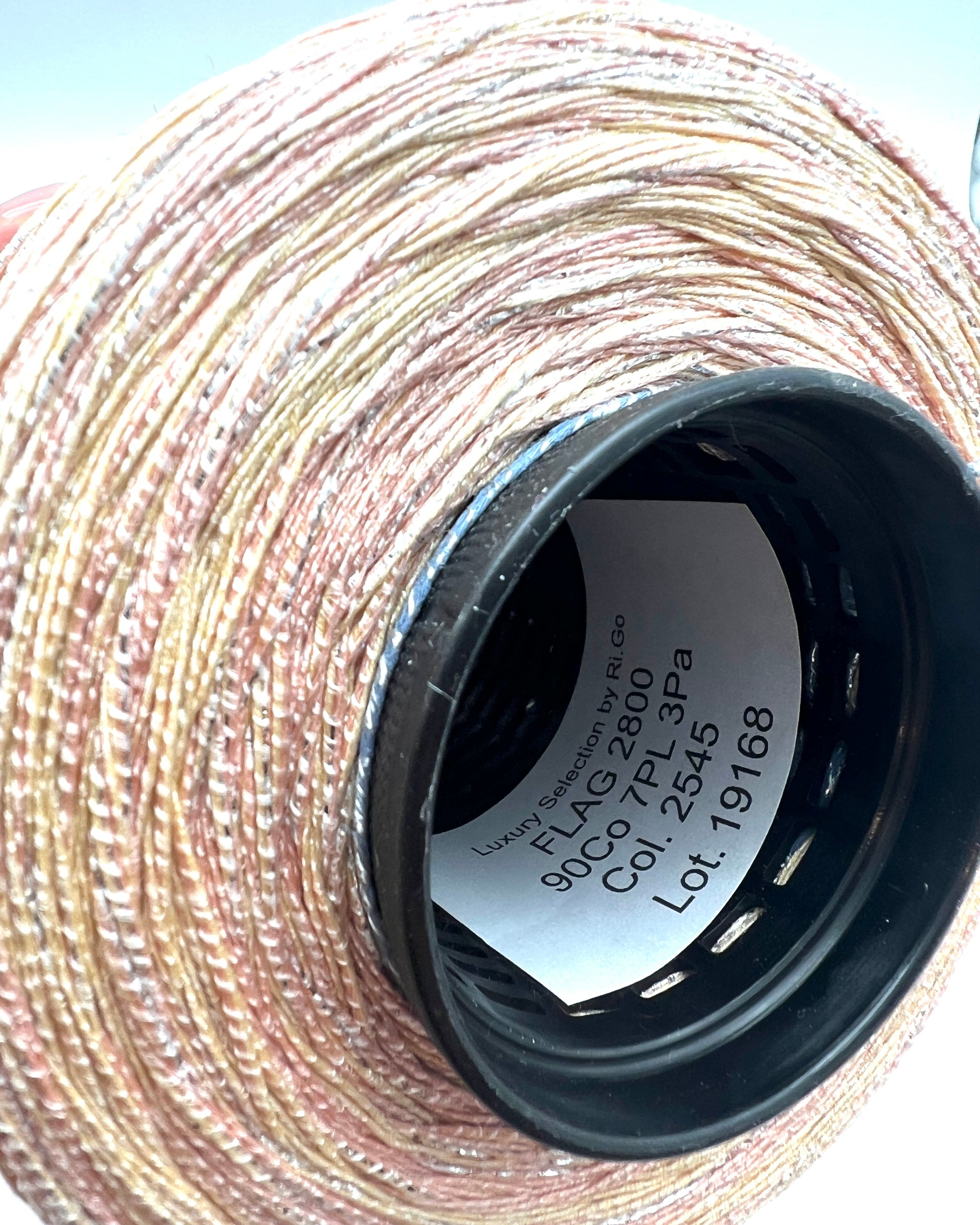 Close-up of a spool of thread with visible label