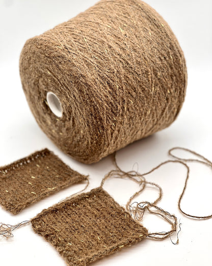 Roll of brown jute twine with a few strands spread out on a white background