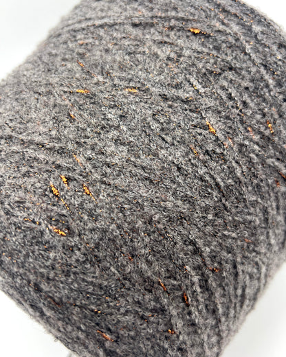 Close-up of a gray yarn ball with visible texture on a white background