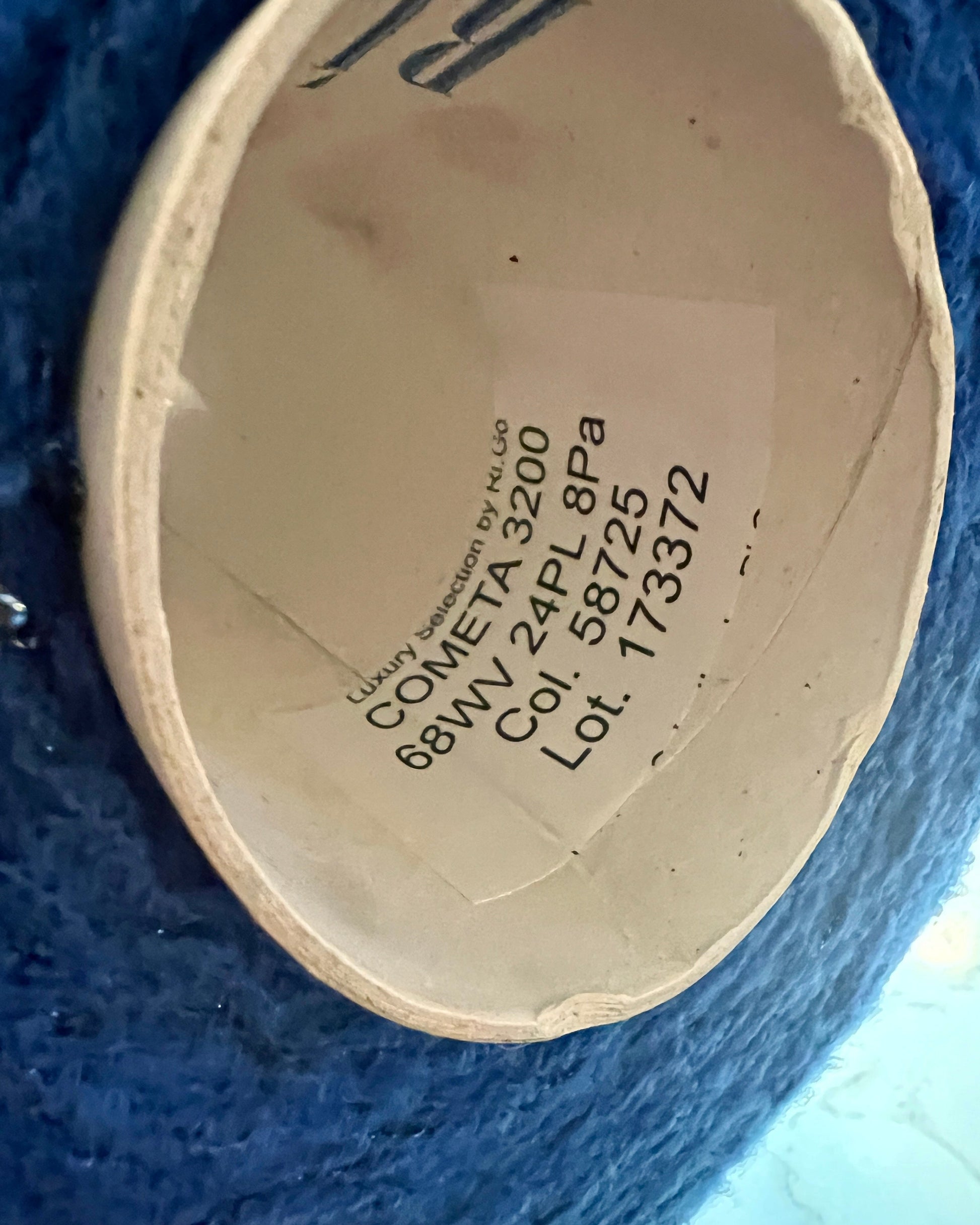 Close-up of a product label with text on a blue background