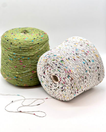 Two rolls of colorful yarn on a white background