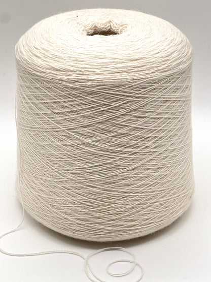 Spool of white yarn on a light gray background