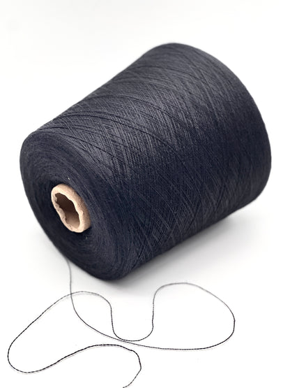 Spool of dark blue thread on a white background