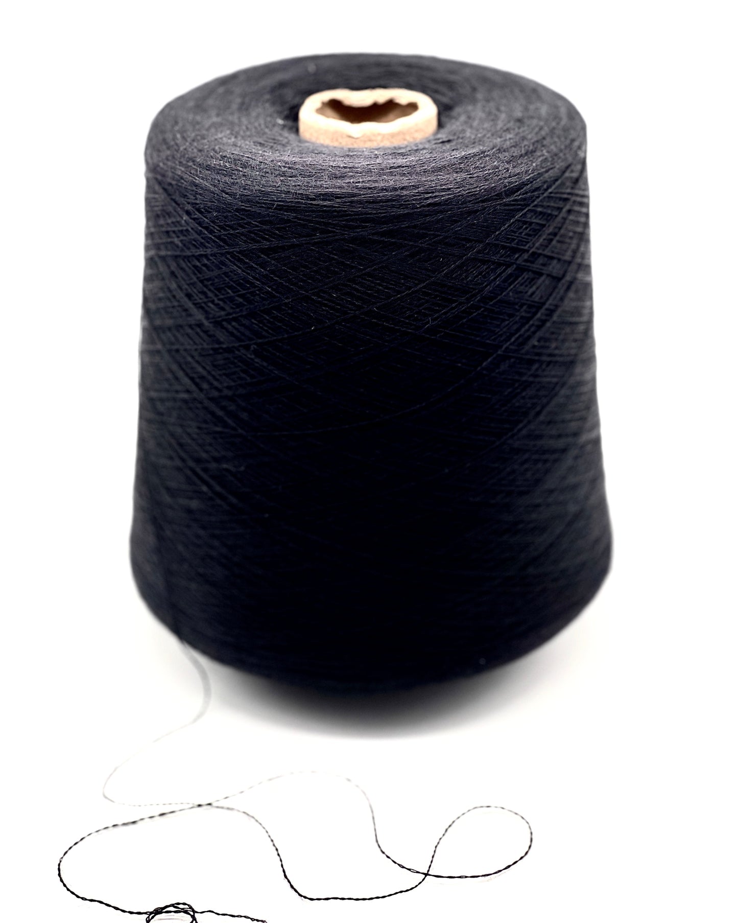 Spool of dark blue thread on a white background