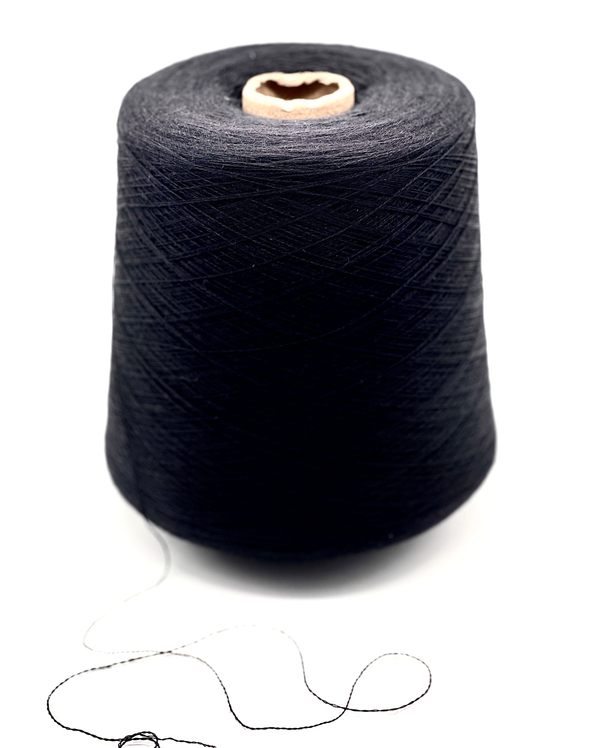 Spool of dark blue thread on a white background
