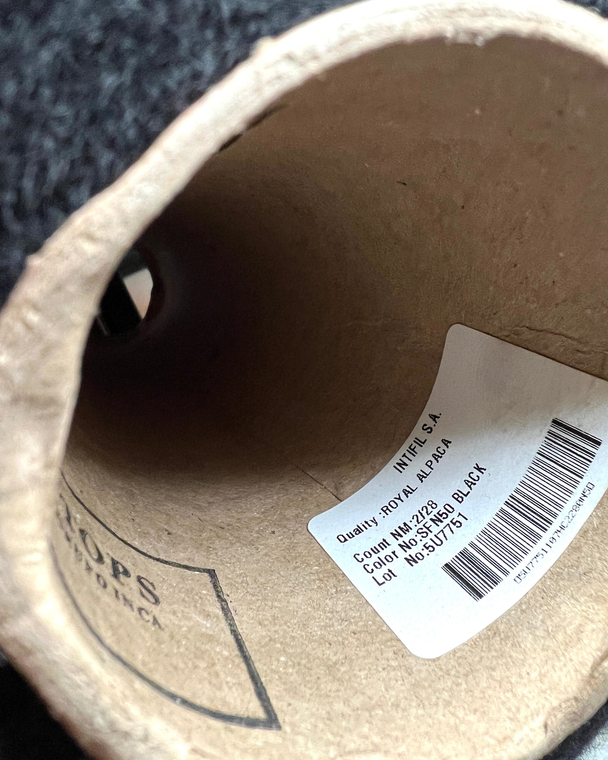 Cardboard tube with a label inside, showing brand and product details.