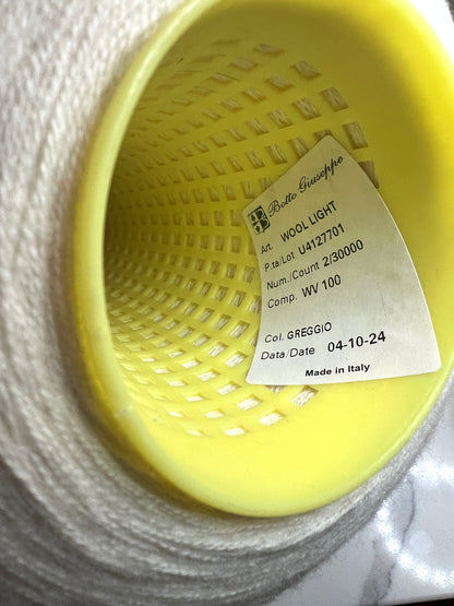 Yellow woven basket with a label on a white background