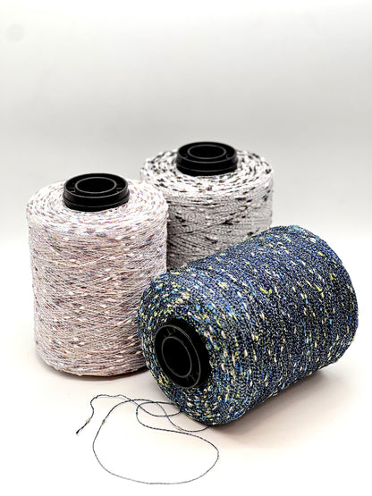 Three spools of thread in different colors on a white background