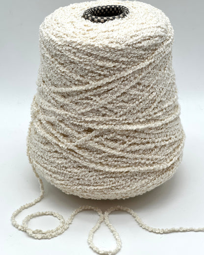 Italian cotton bouclé yarn on cone with looped textured surface