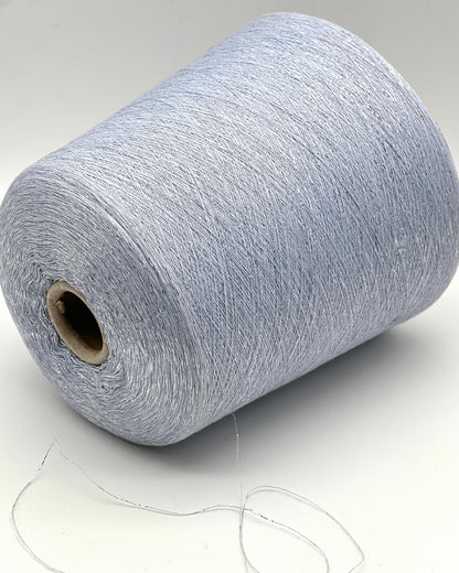 A luxurious cone of Pecci Filati SHIMMER yarn, a modern 50% Cotton, 25% Linen, 14% Polyester, and 12% Polyamide (Lurex) blend. The image showcases the refined metallic glow and delicate texture of this 3400m/100g Italian extrafine yarn, ideal for high-end blending. Authentic luxury fiber available at iDOKNiT.com.