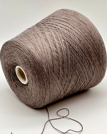 Large spool of brown thread on a white background