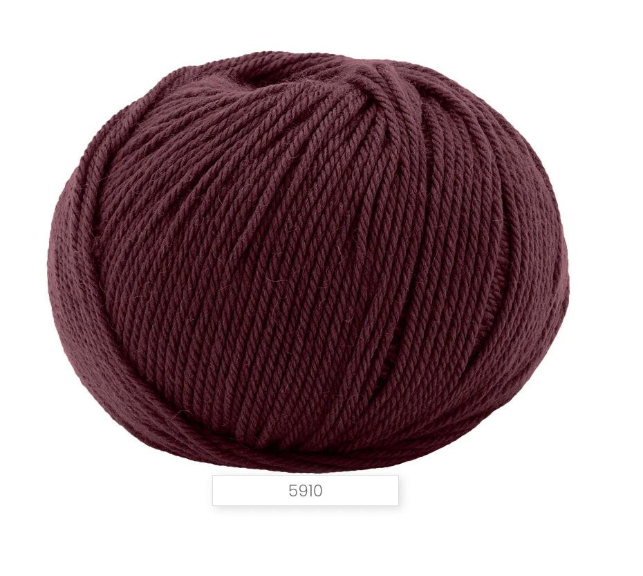 Ball of dark red yarn on a white background