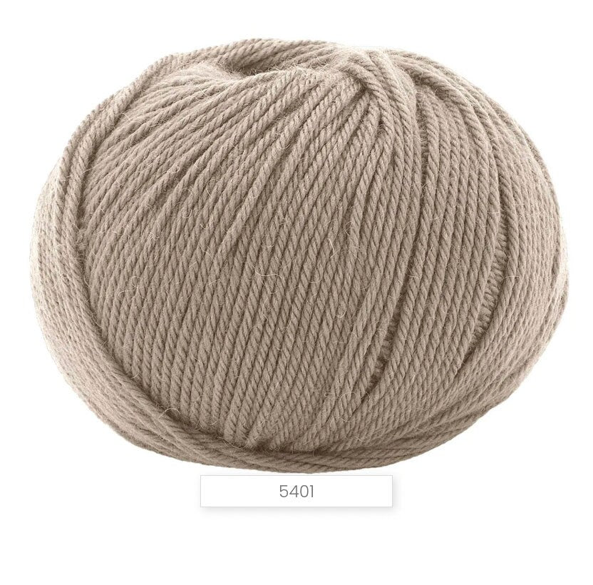 Ball of beige yarn on a white background