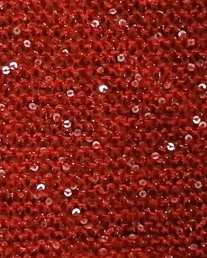 Close-up of red fabric with embedded sequins