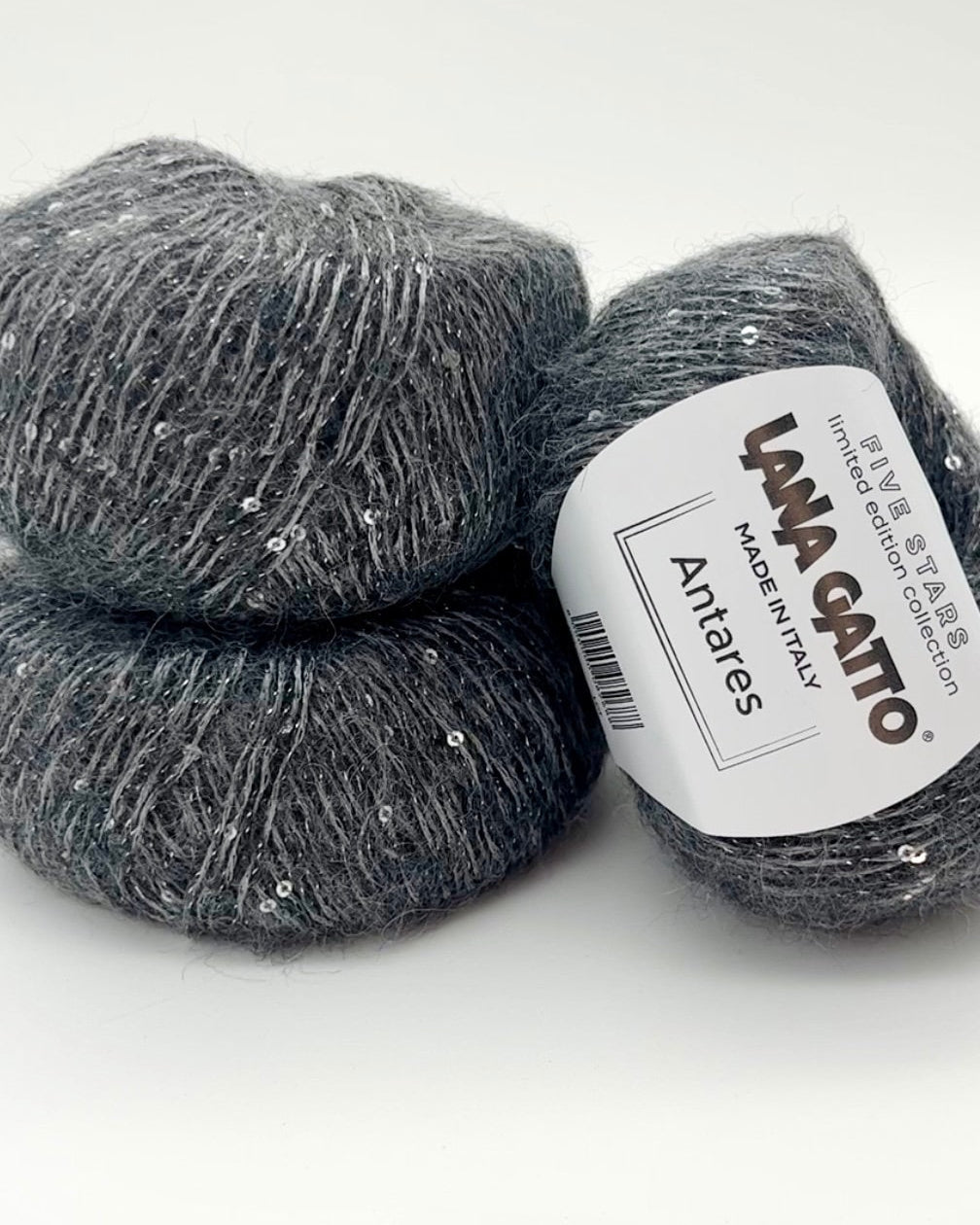 Two balls of gray yarn with a LANA GATTO label on a white background
