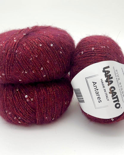 Two balls of red yarn with a label on a white background
