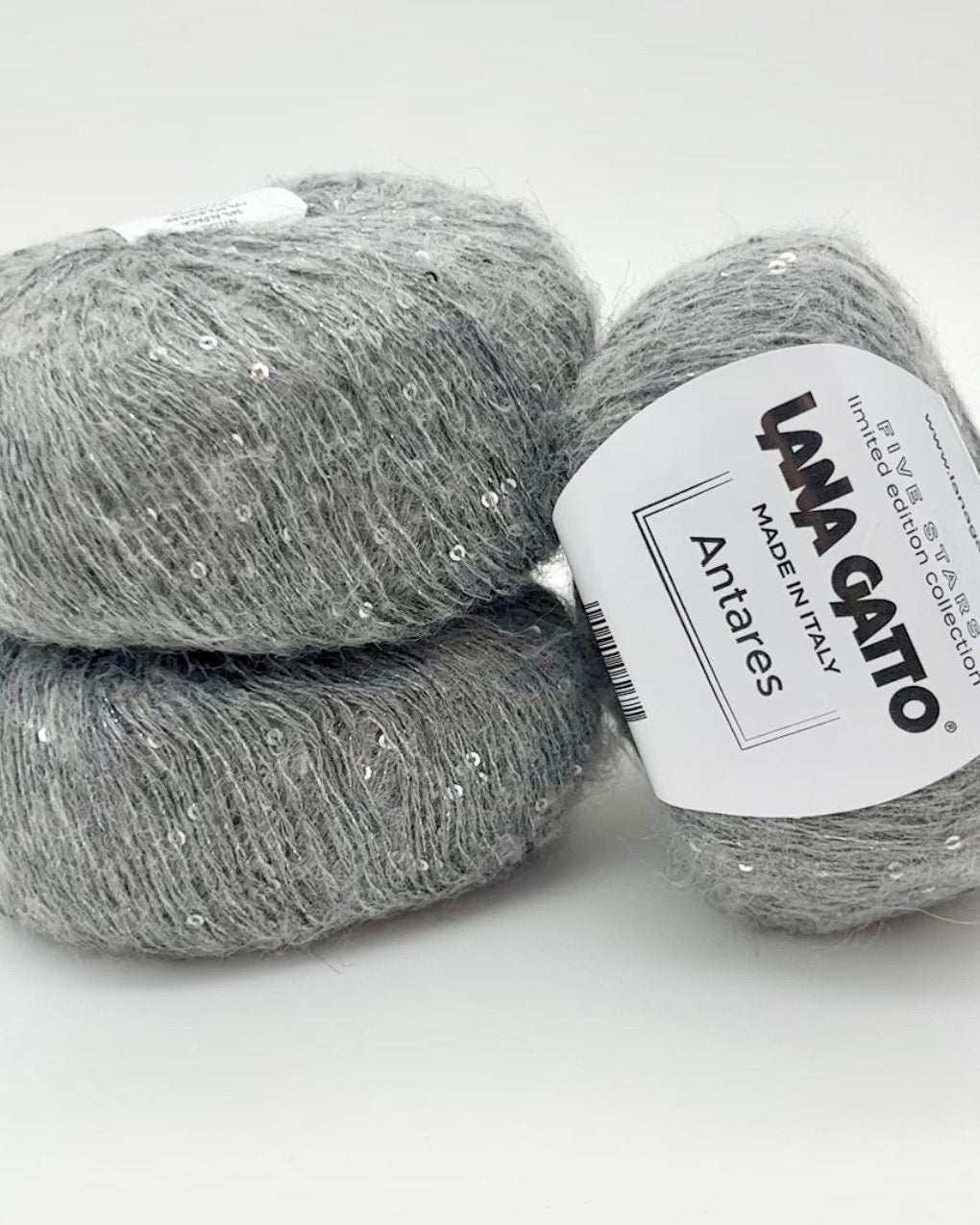Two balls of gray yarn with a Lana Grossa label on a white background