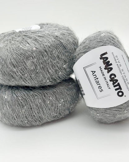 Two balls of gray yarn with a Lana Grossa label on a white background