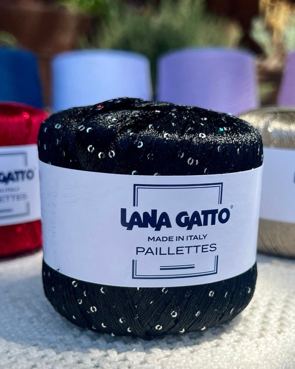 Lana Gatto Paillettes yarn in shimmering pastel tones, with delicate 2mm sequins, lightweight polyester yarn ideal for adding sparkle to knit or crochet projects. Made in Italy. 8606 Black color.
