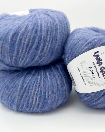 Two blue skeins of yarn with a label on a white background