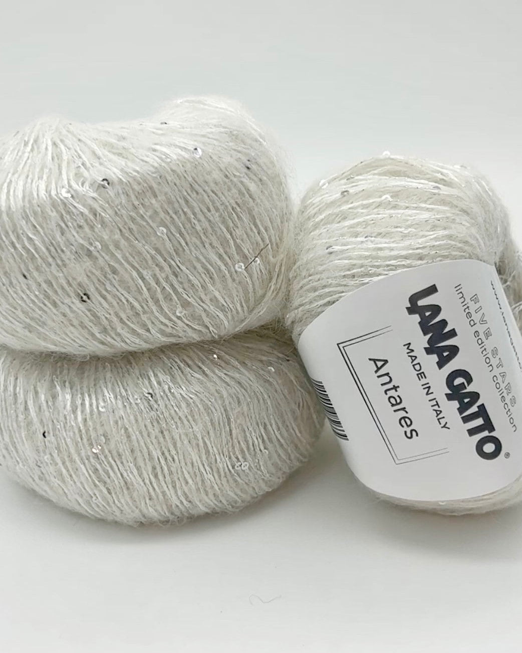 Two balls of yarn with a label on a white background