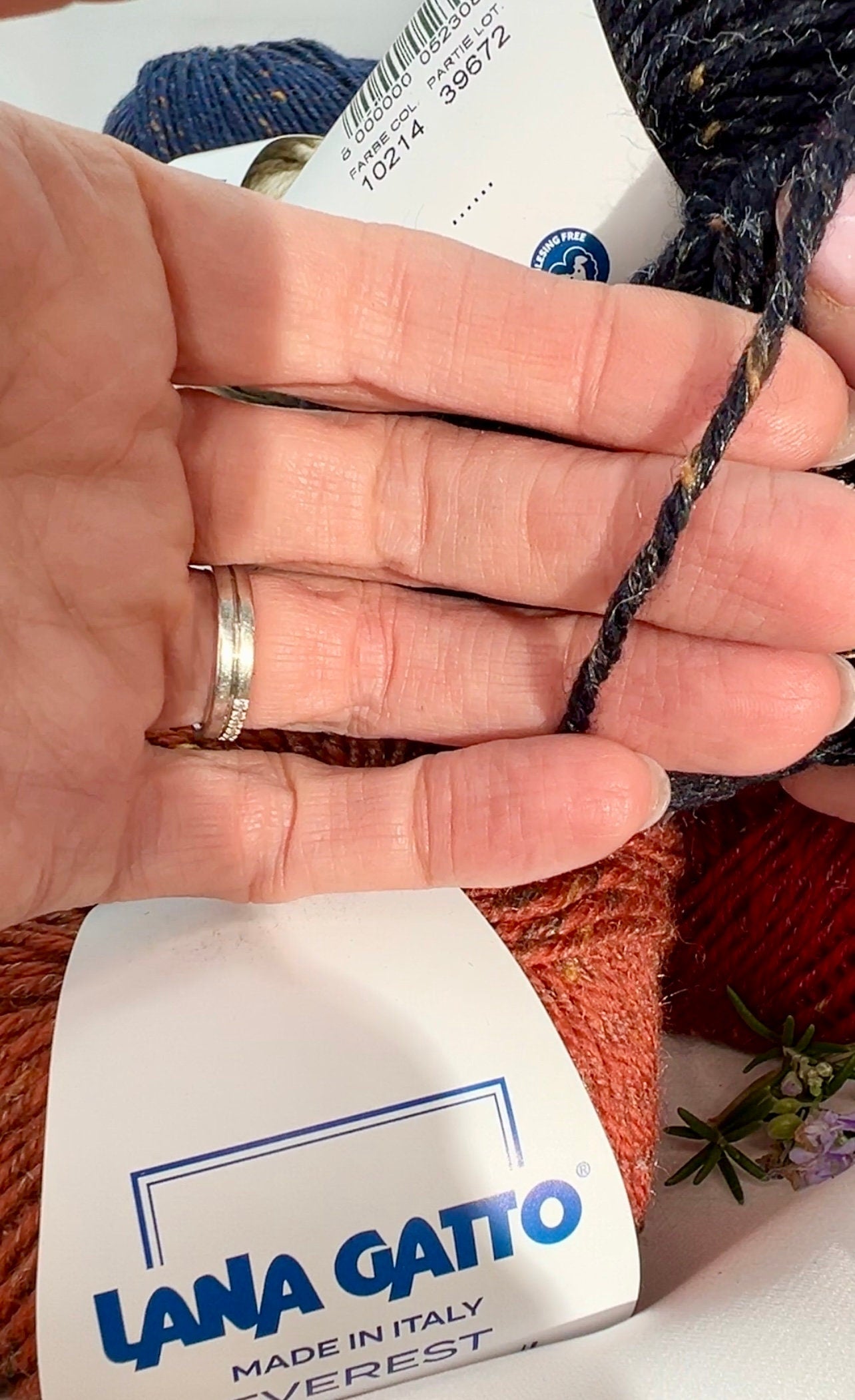 Close-up of iDOKNiT Lana Gatto EVEREST tweed yarn, showing the rustic texture of the Merino and Viscose blend with signature colorful neps in a 50g ball.