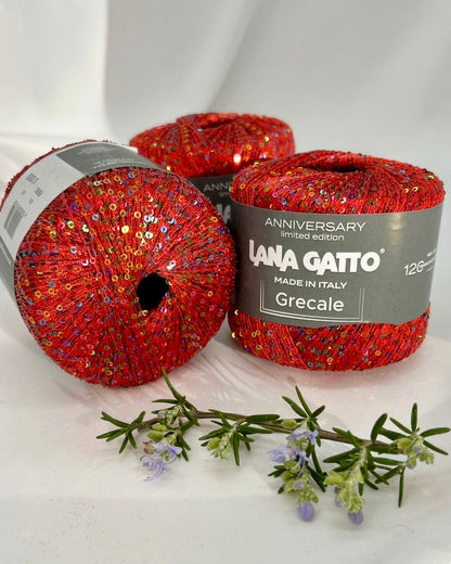 Three balls of red yarn with 'Lana Gatto' label on a white background